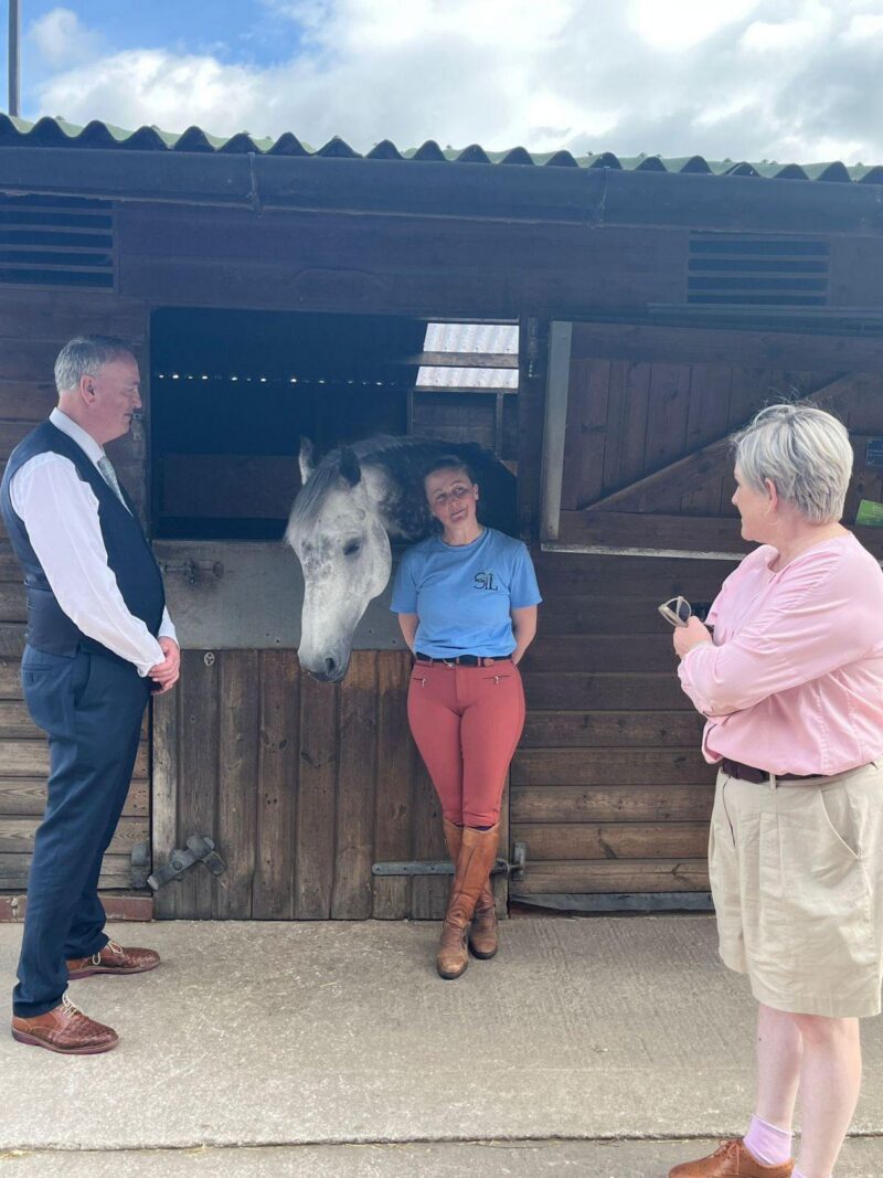 Clive Grunshaw Police and Crime Commissioner, Carrie Byrom, Director of Stable Lives and Ashley Dalton MP with a horse.