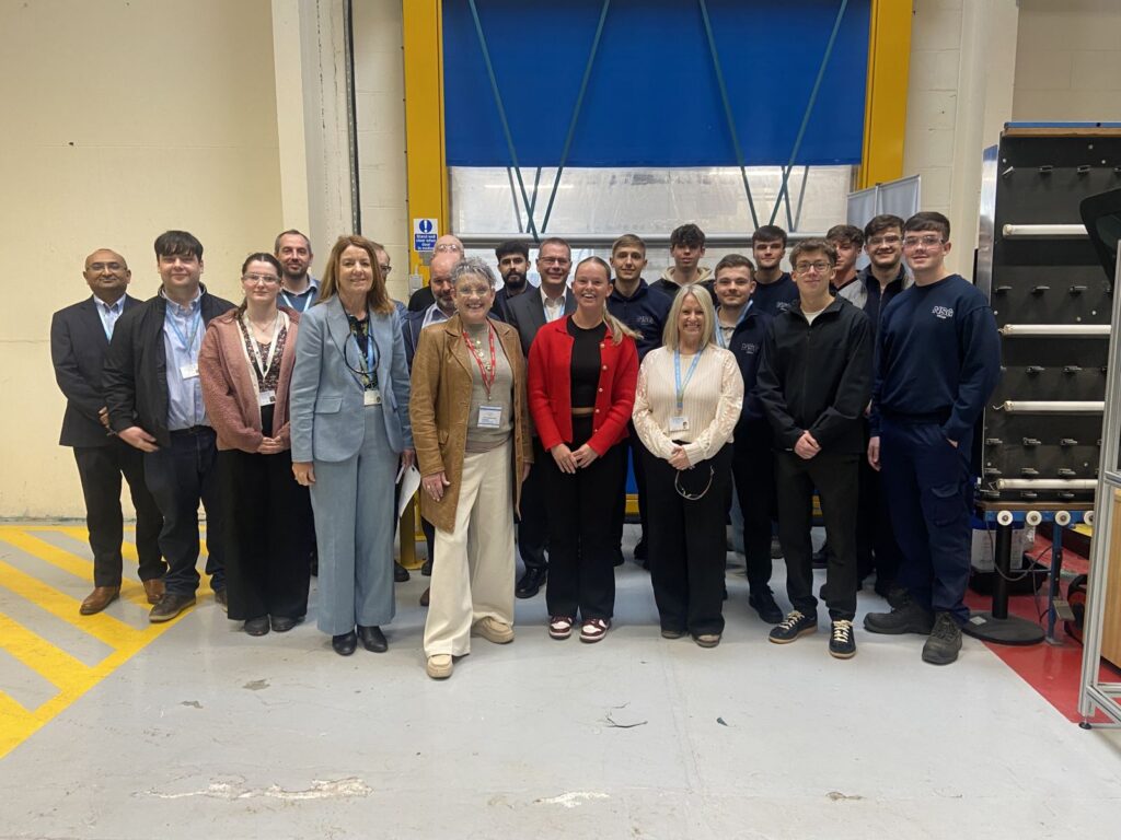 Ashley Dalton with a group of apprentices and other staff at NSG Group, Lathom.